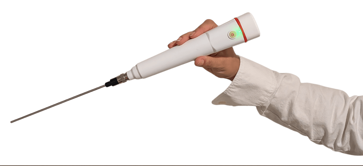 FREEVIEW all-in-one wireless endoscope held in clinician's gloved hand showing the compact ergonomic form